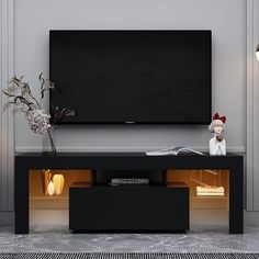 an entertainment center with a large flat screen tv mounted on it's side wall