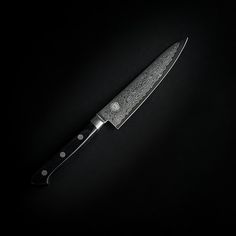 a knife on a black background with white dots