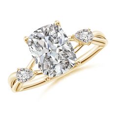 a yellow gold ring with a cushion cut diamond and three pear shaped diamonds on the band