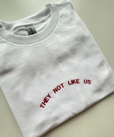 They Not Like Us, Embroidered T-shirt, Monogram, Funny T-shirt, Unisex, SHIPPING INFO: FREE UK DELIVERY are sent as 1st Class (1-2 Working days) UK EXPRESS (Next day delivery) this is an extra cost at checkout Europe sent as International Tracked (Expected 3-5 working days) Worldwide sent as International Tracked (Expected 5-7 working days) EMBROIDERY THREAD: POLYESTER T-SHIRT: 100% COTTON (WHITE 170 GSM) (OTHER COLS 180 GSM) SWEATSHIRT: 80% COTTON, 20% POLYESTER (WHITE + HEATHER GREY 260 GSM) ( T Shirt Embroidery, T-shirt Broderie, Embroidery Tshirt, White Heather, Grey T Shirt, Embroidered Tshirt, Funny T Shirt, Gray Tshirt, Embroidery Thread