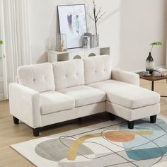 a living room with a white couch and rug