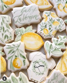 decorated cookies with lemons and leaves are displayed on a table for guests to eat