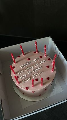 a birthday cake in a box with candles on it