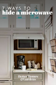 a microwave oven sitting inside of a kitchen next to white cupboards and counter tops