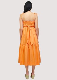 Get ready to turn heads in our Paradiso Midi Dress! Made from soft cotton poplin in a beautiful apricot shade, this dress is a true sun dress silhouette. Its relaxed fit and easy midi length make it the perfect choice for sunny days. Complete your look with sandals and a sun hat. WDWH23282 Imported Lined Self: 100% CottonLining: 100% Rayon Model is 5 ft 9.5 inches; Bust: 32", Waist: 24", Hips: 34" and wearing a size Small Runs true to size Hand wash or wash with gentle cycle with cold water with like colors, Air dry to avoid shrinkage Cotton Midi Sundress For Brunch, Orange Knee-length Summer Midi Dress, Orange Midi Sundress For Spring, Summer Orange Cotton Maxi Dress, Orange Summer Midi Dress, Orange Summer Midi Dress For Brunch, Orange Midi Dress For Summer, Orange Cotton Midi Dress For Vacation, Orange Maxi Dress For Summer Daywear