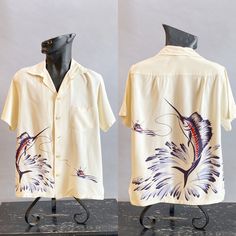 "~A rare find ~1940s Hand Printed Marlin Shirt by Catalina ~Color is very strong and bright ~Heavy rayon ~Screen printed front and back ~Original celluloid button ~Pointed collar with loop Top-stitched front pocket, short sleeves hem and bottom see below about shipping Size- Medium (label) but measures large Chest - 46\" Shoulders - 18\" Length - 27 1/2\" Labels:  Catalina   a California Creator;   label back:   Styled for the Stars of Hollywood  * Los Angeles, Calif   reg. U.S. Pat. Off.   Made Vintage Fitted Hawaiian Shirt With Short Sleeves, Vintage Fitted Short Sleeve Hawaiian Shirt, Fitted Vintage Hawaiian Shirt With Short Sleeves, White Vintage Camp Shirt With Relaxed Fit, Vintage White Relaxed Fit Camp Shirt, Vintage White Shirt With Camp Collar, Vintage Fitted Camp Shirt With Camp Collar, Vintage Fitted Camp Collar Shirt, Vintage Fitted White Camp Shirt