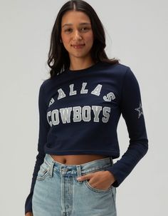 Dallas Cowboys Long Sleeve Baby Tee. Show Your Team Pride With This Dallas Cowboys Long Sleeve Baby Tee. Featuring "dallas Cowboys" Screened Across The Front Chest And A Bold Star Graphic On The Left Sleeve, This Fitted Tee Is Perfect For Fans Looking For A Stylish And Sporty Look. Ideal For Game Day Or Casual Wear! 94% Cotton, 6% Spandex. Machine Wash. Imported. Model Is Wearing A Size Small. Model Measurements:height: 5'8" Bust: 32"waist: 24"hips: 35" Collegiate Style Fitted Tops For Spring, Fitted Tops For Game Day In Spring, Long Sleeve Tops With Text Print For School Spirit, Blue Fitted Tops For College, Collegiate Style Text Print Top For Fall, Collegiate Style Blue Tops For Fall, Collegiate Letter Print Tops For Fall, Spring Long Sleeve Tops For Game Day, Spring Game Day Top With Text Print