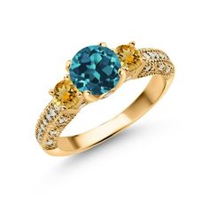 a gold ring with an oval blue topazte and two yellow diamonds on the sides