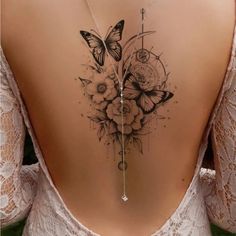 the back of a woman's neck with flowers and butterflies on it, as well as a clock