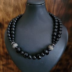 "This is an exquisite vintage short length/ choker necklace made out of genuine black onyx stones, 2 sterling silver spacer beads which are embellished with marcasite stones, and a sterling silver toggle clasp.  2 strands of round black onyx beads on both sides then 2 sterling spacers and one strand in between which contains round and faceted black onyx gemstones.  There's no mark on this necklace but the toggle clasp and spacers are individually tested and they are sterling silver.  In excellen Black Double Strand Faceted Beads Jewelry, Elegant Onyx Beads For Jewelry Making, Elegant Black Sterling Silver Beaded Necklaces, Vintage Black Gemstone Beads Necklace, Black Double Strand Polished Bead Jewelry, Black Beaded Rondelle Jewelry, Black Rondelle Gemstone Beaded Jewelry, Elegant Black Rondelle Beaded Necklaces, Black Rondelle Gemstone Beads Jewelry