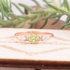 "Simple & dainty 14k rose gold peridot promise ring for her, Elegant 3 stone womens promise ring, Gold 3 stone peridot engagement ring WE OFFER UNLIMITED PERIOD INSTALLMENTS PLAN This is a beautiful, stunning, feminine ring that works well for all occasions, styles, and ages. You will love it! Ring information Main stone: Peridot Approximate size: 4.5mm Accent stone: Cubic zirconia Approximate size: 3mm Metal type: Gold Metal stamp: 14k solid gold Customization / Replacements It's easy to cr Adjustable Peridot Jewelry For Anniversary, Three-stone Fine Jewelry For Proposal, Rose Gold Three-stone Promise Jewelry, Fine Jewelry Three Stone For Proposal, Three Stone Fine Jewelry For Proposal, Three Stone Round Jewelry For May Birthstone, May Birthstone Three Stone Round Jewelry, Three Stone Peridot Jewelry As Gift, Three Stone Round Jewelry For Proposal