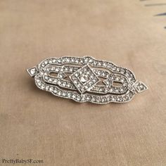 Art Deco brooch, silver, Great Gatsby brooch, wedding brooch, bridal brooch pin Downton Abbey DECO DIAMOND BROOCHPLEASE SEE SHIPPING TAB FOR TURNAROUND TIMEArt Deco Great Gatsby style brooch with loads of clear glass crystals in an Art Deco setting. Very very Art Deco! also available as a comb (last photo):https://www.etsy.com/listing/187298224/art-deco-hair-comb-great-gatsby-comb?ref=shop_home_active_4&ga_search_query=diamondembellishment Approx 2 1/2" / 6.8 cm across wide by 1”  / 2.5 cm t Victorian Wedding Brooches With Intricate Design, Antique Wedding Brooch With Intricate Design, Classic Wedding Brooches With Intricate Design, Silver Art Deco Brooches For Wedding, Ornate Wedding Brooches With Intricate Design, Silver Art Deco Wedding Brooches, Ornate Wedding Brooch With Intricate Design, Silver Art Deco Wedding Brooch, Ornate Wedding Brooch Jewelry