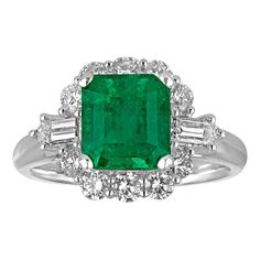 an emerald and diamond ring set in white gold