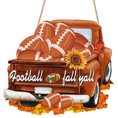 an orange truck with football balls in the back and sunflowers on the side