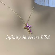 "The pendant pictured has lab created pink sapphires #7044 This cross is also shown with different color stones: #7042 lab created ruby #7043 lab created blue sapphire #7045 moissanite -Approximate total carat weight: approx. .67ctw diamond equivalent -Center Stone Size: 11 stones - approx. 0.67ctw diamond equivalent -Center Stone Shape: round -Gem Type: lab created sapphire -Stone Clarity: VS2 -Stone Color: Pink -Moh's Scale: 9 hardness -Metal Type and Purity: 14k yellow gold -Setting: shared p Pink Cross Pendant Necklace For Gift, Cross-shaped Birthstone Necklaces As Gifts, Hot Pink Cross Necklace, Luxury Cross-shaped Gemstone Necklace, 11 Stone, Pink Sapphire Pendant, Sapphire Stones, Color Stones, Gold Cross Necklace