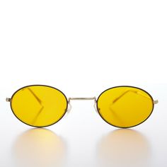 Housed in a stylish oval gold frame this sunglass features the highly coveted yellow, vision-enhancing, blue blocker lens. For all you vintage lovers out there, this is the original 90s oval, yellow lens sunglass for you. Never worn. New Old Stock. Excellent Condition. Made in China in the 90s. FIT INFORMATION 50mm Eye Size 25mm Bridge 140mm Temple/Arm Width 5 1/4 Inches Height 1 1/2 Inches International Buyers – Please Note:  Import duties, taxes, and charges are not included in the item price Eclectic Clothes, Small Sunglasses, Yellow Sunglasses, Fallen London, Vintage Lovers, Yellow Aesthetic, Oval Sunglasses, Oval Frame, Vintage Lover