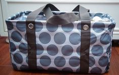 a large polka dot bag sitting on top of a wooden floor