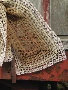 an old piece of cloth sitting on the side of a train car that is rusted