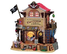 a small building with lots of decorations on it's front and side windows, including a pirate flag flying from the roof