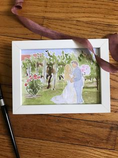 a watercolor painting of a bride and groom on a wooden floor with a pink ribbon