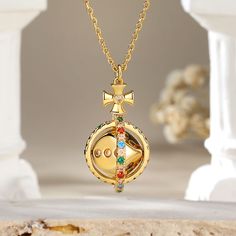 The pendant features a delicate circular frame adorned with an array of vibrant colored stones. At its heart lies a captivating surprise – a dice that gracefully rotates 360°, symbolizing the unpredictability of life's adventures. This unique piece not only reflects your sophisticated taste. Adorn yourself with this exquisite necklace, and let the world witness your flair for both beauty and whimsy.Carat Weight: 0.994 ctStone Size: 1.5,1.6,1.8,2,1.5,1.5 mmNumber of Stones: 73 Stone Color: Garnet Symbolic Jewelry With Detachable Pendant As Gift, Gold Multi-stone Spiritual Necklace, Gold Multi-stone Necklace With Spiritual Style, Luxury Multicolor Birthstone Jewelry, Gold Spiritual Necklace With Multi-stone, Spiritual Gold Necklace With Multi-stone Details, Symbolic Multicolor Pendant Jewelry, Gold Multi-stone Round Pendant Jewelry, Multicolor Jewelry With Detachable Pendant As Gift