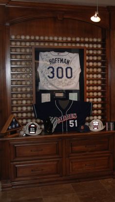 a baseball jersey is on display in the dugout with other sports memorabilia around it