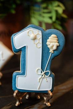 a blue and white cake shaped like the number one