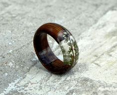 a wooden ring sitting on top of a cement ground