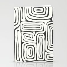 a black and white greeting card with an abstract pattern on the front, featuring lines that appear to be interlocked