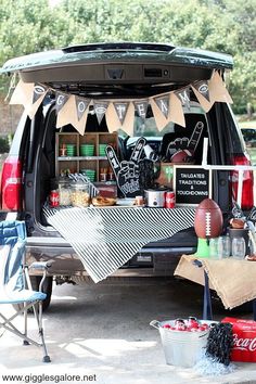 the back end of a vehicle with an american football themed tailgater on it