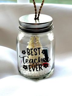 a glass jar filled with white and black beads