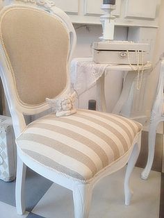 a white chair sitting in front of a mirror on top of a checkered floor