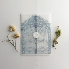 a white and blue gate with flowers on the side next to it, surrounded by petals