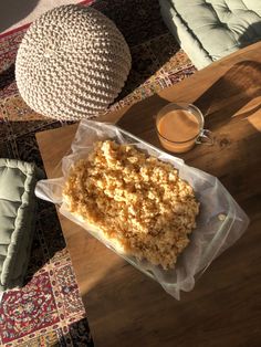 a table with some food on top of it and a cup of coffee next to it