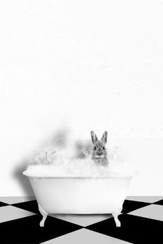 a rabbit in a bathtub with bubbles coming out of it