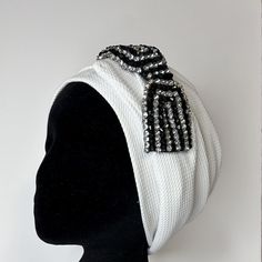 Combining functional and style - Textured white pull on luxury turban for women. This turban is a self tie wrap around  pull on beanie. pull on the cap and  wrap the tie along the turban to create a volume  clip the ties down with the silver bow  An excellent protective styling head cover choice Turban for Women. Handmade in Canada  from Soft and lightweight  light scuba fabric. Feel beautiful  and confident in this pull on headpiece.  You can wear it everyday, while away on holidays and for occasions add a wow effect to it by dressing it up with a brooch. wear with or without hair. An essential hair fashion accessory, for covering your head , take along on a holiday  use by  the beach or pool side  or when if you are  undergoing hair loss from alopecia or chemotherapy. Size one standard Turban For Women, Stylish Scarves, Scuba Fabric, Tie Wrap, Rhinestone Bow, Silver Bow, Feel Beautiful, Turbans, Mesh Bag