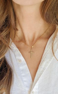 14k Gold-filled sparkle chain cross necklace!  This necklace is intricate and delicate necklace is perfect given as. baptism gift.  This necklace brings elegance to every outfit!  This necklace, like all our chain products comes with an extender chain. 🤍14k Gold filled chains and findings 🤍All Gold Filled Findings, so items will not tarnish✨ 🤍Come packaged and ready to gift.  🤍 Hypoallergenic jewelry that will last!    ⚜️ Gold filled products differ from gold plated.  Here are the major differences. Gold Filled: ✔️Affordable cost and great quality  ✔️Great for everyday wear ✔️Leave it on even when showering, water resistant! ✔️Tarnish resistant  ✔️Hypoallergenic  ✔️Gold layer is thicker than gold plated and bonded to base metal rather than painted on! Gold Plated ‼️OUR JEWELRY IS NOT G 14k Gold Filled Cross Necklace Gift, 14k Gold Filled Cross Pendant Necklace As Gift, Gold Cross Necklace With Delicate Chain As Gift, Gold Crucifix Necklace For Wedding, Gold Dainty Cross Pendant Charms, Gold Delicate Chain Cross Necklace, Delicate Gold Cross Pendant Necklace, Delicate Gold Cross Necklace With Delicate Chain, Gold Cross Pendant Necklace For First Communion