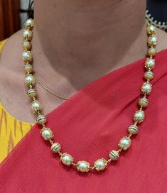 22 karat gold necklace with culture pearls
    

discover the epitome of elegance with our 22 karat gold necklace with culture pearls. handcrafted in india by totaram jewelers, this exquisite piece showcases the perfect blend of traditional artistry and modern design.
  
  immerse yourself in the allure of culture pearls, weighing a stunning 63.35 carats. each pearl is meticulously selected to radiate their natural beauty, making this necklace a true statement of sophistication. the go Elegant Bridal Necklace With Zari Work For Puja, Gold Pearl Necklace With Cutdana For Festive Occasions, Festive Gold Pearl Necklace With Cutdana, Elegant Dual-tone Temple Necklace For Puja, Elegant Dual-tone Necklace For Puja, Elegant 22k Gold Temple Necklace For Puja, Elegant Yellow Necklace For Puja, Elegant Yellow Gold Temple Necklace With Pallu, Gold Bridal Necklace With Cutdana And Round Beads