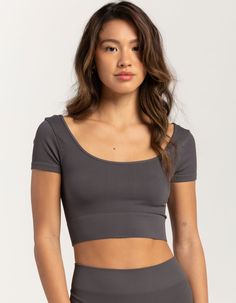 Tilly's Seamless Double Scoop Top. A Sleek And Versatile Addition To Your Wardrobe. Crafted With Stretchy Ribbed Fabric, This Top Offers A Form-Fitting Silhouette That Hugs Your Curves In All The Right Places. Scoop Neckline. Cropped Length. 92% Nylon, 8% Spandex. Hand Wash. Made In Usa. Model Is Wearing A Size S/m. Model Measurements:height: 5'6" Bust: 32"waist: 26"hips: 35" | Tillys Seamless Double Scoop Top Seamless Scoop Back Crop Top, Gray Top With Built-in Bra And Medium Support, Stretch Seamless Scoop Neck Top, Seamless Scoop Neck Crop Top For Workout, Seamless Stretch Scoop Neck Top, Scoop Neck Seamless Crop Top For Yoga, Yoga Scoop Neck Seamless Crop Top, Medium Support Scoop Neck Crop Top, Stretch Seamless Top With Scoop Back