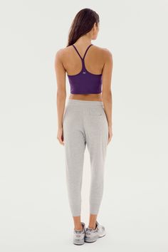 Our best-selling classic cropped sweatpant in ultra luxe fleece, Reena will become your go to piece for every day wear. Pair it with the Warm Up Fleece Pullover and enjoy effortless fit and pure comfort. BEST FOR: Chilling out after running, yoga, CrossFit, barre, Pilates, cycling and spin class. Model Stats:Height: 5’10”, Bust: 32", Waist: 23”, Hips: 34”Wearing size: Small Sportswear Activewear With Elastic Waistband For Loungewear, Athleisure Yoga Pants For Loungewear, Stretch Cropped Bottoms For Loungewear, Lounging Sportswear With Elastic Waistband, Athleisure Yoga Pants For Lounging, Sporty Yoga Pants For Lounging, Solid Color Athleisure Activewear For Lounging, Solid Cropped Pants For Loungewear, Solid Cropped Loungewear Pants