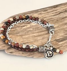 This beautiful Bohemian Bracelet is made with high quality  4mm round  Red  Creek Jasper beads. Semi precious stones with genuine brown braided leather and stunning silver chain! It's made with attention to detail, delicate yet has the bohemian style and detailing with that layered look. It has three stands of texture combined together complimenting one another and giving a unique original one of a kind style! Each end has a silver Tibetan bead adding additional detail and style! It's made to wr Leather Beaded Bracelet, Red Creek Jasper, Chakra Racine, Bohemian Bracelet, Bohemian Bracelets, Boho Bracelet, Bracelet Boho, Jasper Beads, Bead Leather