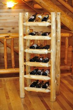 a wooden wine rack filled with bottles on top of a hard wood floored floor