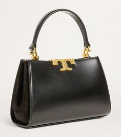 Find TORY BURCH Mini Eleanor Top-handle Bag on Editorialist. Tory Burchs timeless Eleanor satchel bags breathe elegant luxury into your day-to-day, and this petite iteration is no exception. It features the structured, boxy shape of its larger counterparts and the same bold curves of sculptural hardware while being the perfect mini size for topping your arm come evening. Designer Tan Top Handle Box Bag, Designer Top Handle Box Bag With Branded Hardware, Classic Top Handle Box Bag With Branded Hardware, High-end Tan Top Handle Satchel, Luxury Tan Box Bag With Gold-tone Hardware, Evening Rectangular Satchel With Branded Hardware, Tan Box Bag With Detachable Double Handle, Classic Tan Box Bag With Top Handle, Tan Top Handle Satchel For Formal Events