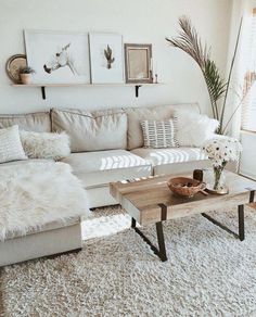 a living room filled with lots of furniture and decor on top of a white rug