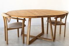 a wooden table with two chairs around it