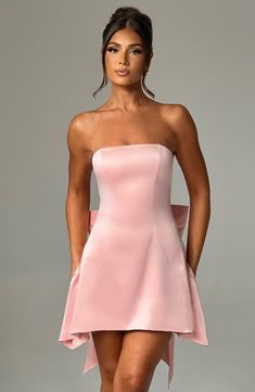 The Freja mini blush dress is party perfection. Crafted in luxurious stretch satin, this beautiful design is strapless with a corseted bodice and flirty, flouncy skirt. A dramatic bow to the back finishes the look. Homecoming Dresses Corset, Strapless Corset, Maxi Dress Sale, Popular Dresses, Sparkle Dress, Blush Dresses, Dresses By Length, Hoco Dresses, Formal Dresses Prom