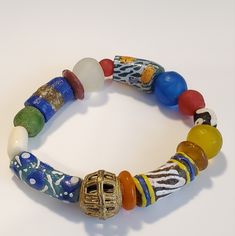 Beautiful Stretch Bracelet Made From African Sea Glass Beads, Colors Of Yellow, Blue, Green And Red. One Brass Filigree Medium Bead Assorted Colors Krobo Beads Measures Stretch Bracelet Measures 5" To - 6" Long, Wrist Glass Bracelets With Colorful Beads For Beach, Colorful Glass Bead Bracelets For Beach, Beach Bracelets With Colorful Glass Beads, Blue Glass Beaded Bracelets For Beach, Large Beads Glass Bracelet For The Beach, Adjustable Glass Beaded Bracelets For Festivals, Beach Beaded Bracelet With Large Glass Beads, Bohemian Blue Glass Bracelets, Blue Bohemian Glass Bracelets