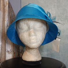 An Aquamarine Bucket Hat Accentuated With A Flower Bow And Black Feathers 100%Polyester Nwt Size:Os Blue Mini Hats For Beach With Short Brim, Blue Mini Hats With Short Brim For Beach, Blue Mini Hat With Short Brim For Beach, Blue Mini Beach Hats With Short Brim, Blue Mini Hats For Spring Beach Occasions, Blue Mini Hats For Summer Beach, Blue Mini Hat For Beach, Adjustable Bucket Hat For Spring Party, Blue Adjustable Mini Hats