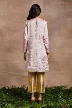 Pink handwoven silk tissue short kurta with silk thread, dori, sequins and patchwork hand embroidery. Comes with banarasi brocade trouser.
Components: 2
Pattern: Hand embroidered
Type Of Work: Thread, Dori, Sequins, Patchwork
Neckline: Round
Sleeve Type: Full
Fabric: Kurta : Handwoven silk tissue, Trouser : Banarasi brocade
Color: Pink
Other Details: 
Side pockets on kurta
Occasion: Mehendi and Haldi - Aza Fashions Festival Silk Sequin Sets, Embellished Silk Dupatta, Silk Kurta With Sequins In Traditional Drape, Silk Kurta With Sequins For Festivals, Banarasi Brocade, Pink Kurta, Short Kurta, Types Of Work, Silk Thread