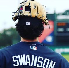 a baseball player wearing a catchers mitt on top of his head